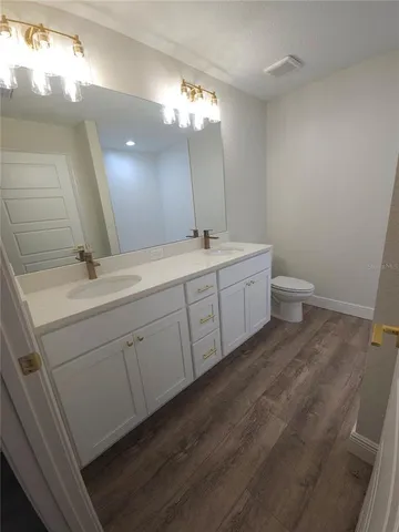 a spacious bathroom with a double vanity sink and a mirror