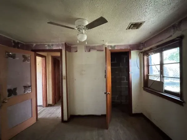 a view of hallway with window and stairs