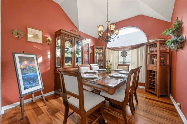 a kitchen with stainless steel appliances granite countertop a lot of counter space and wooden floors
