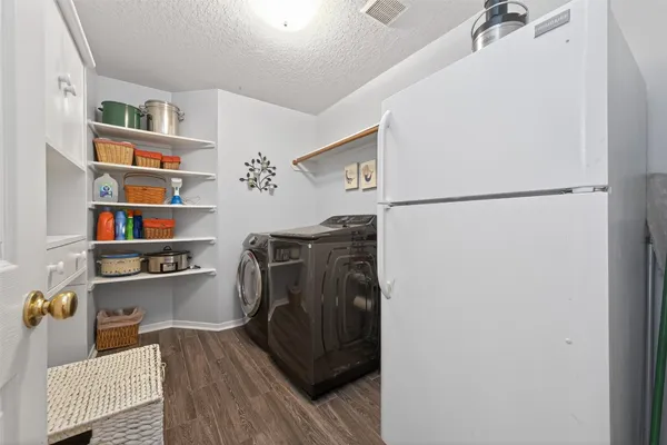 a bedroom with furniture and a flat screen tv