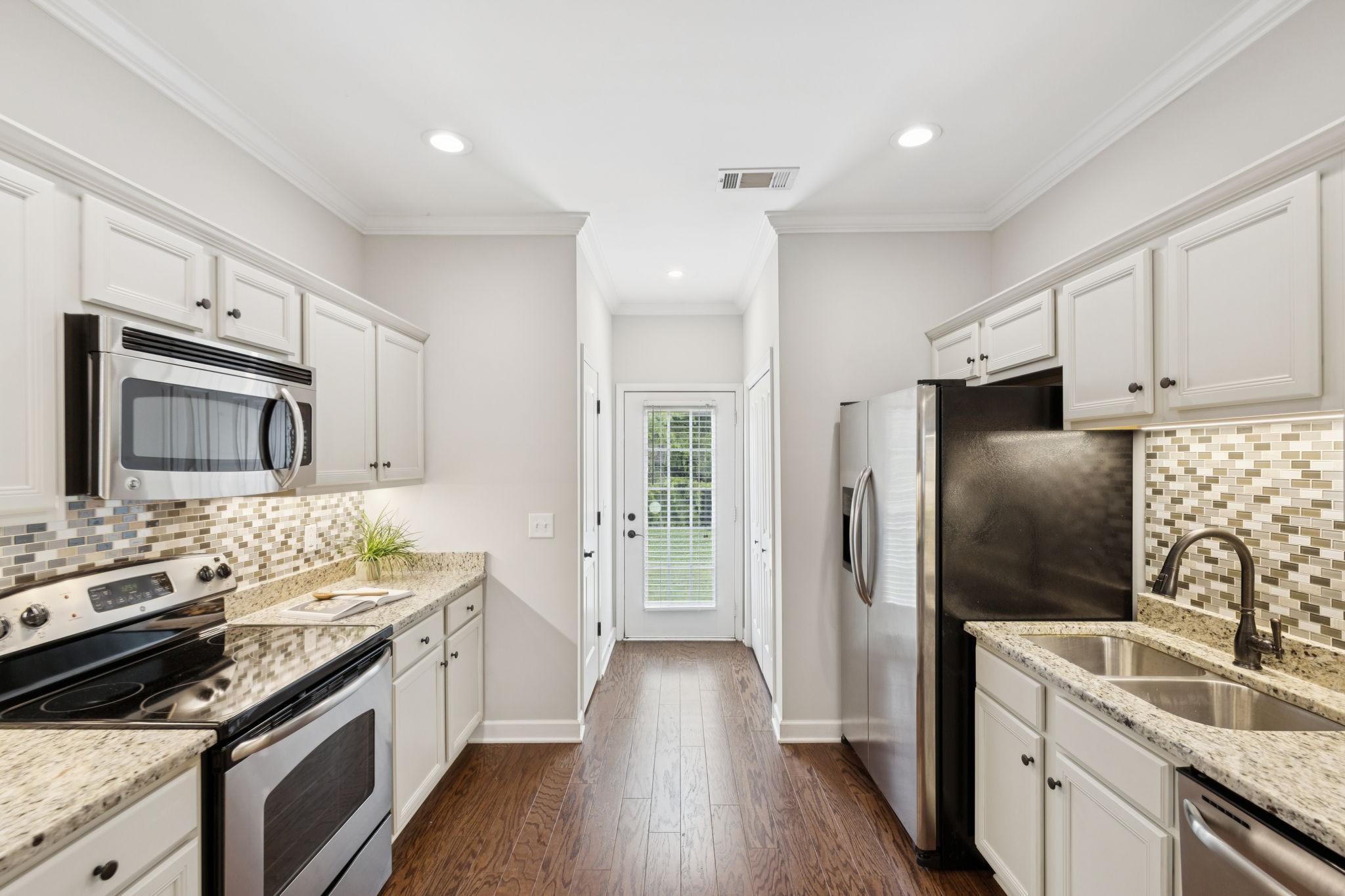 1101 Downs Boulevard, Unit 295 Franklin, TN 37064 - Photo 11 of 33 a kitchen with stainless steel appliances a stove sink and refrigerator