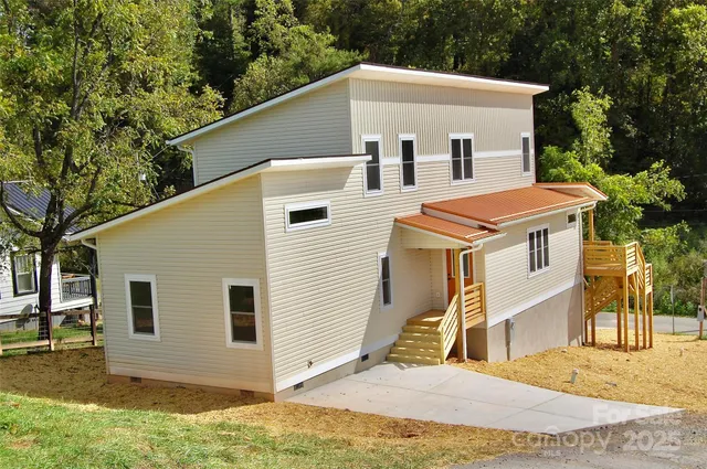 a view of a white house with large windows