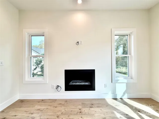 a living room with fireplace and a window