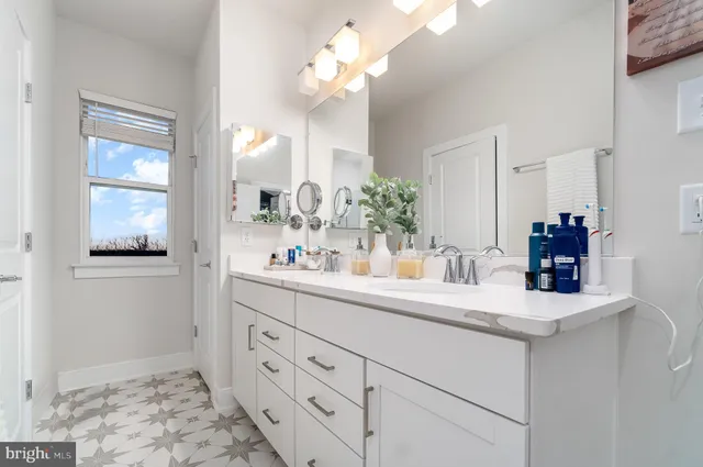 a bathroom with a sink a light fixture and a mirror