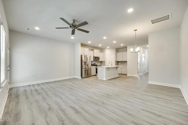 a kitchen with kitchen island a sink and wooden floor