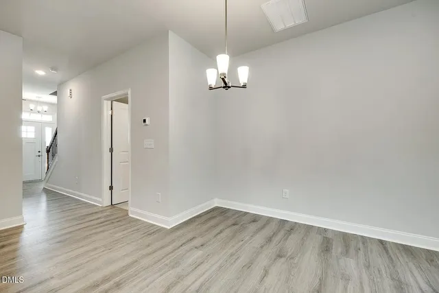 a view of a kitchen with a sink and wooden floor