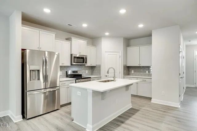 a view of a hallway with wooden floor and stairs