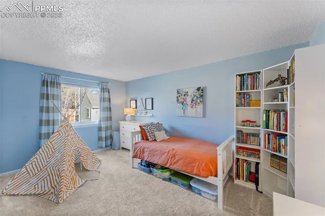 a bedroom with a bed and a book shelf