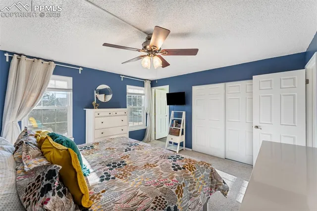 a bedroom with a bed and a television