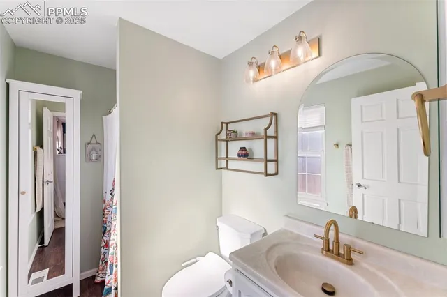 a bathroom with a sink mirror and toilet