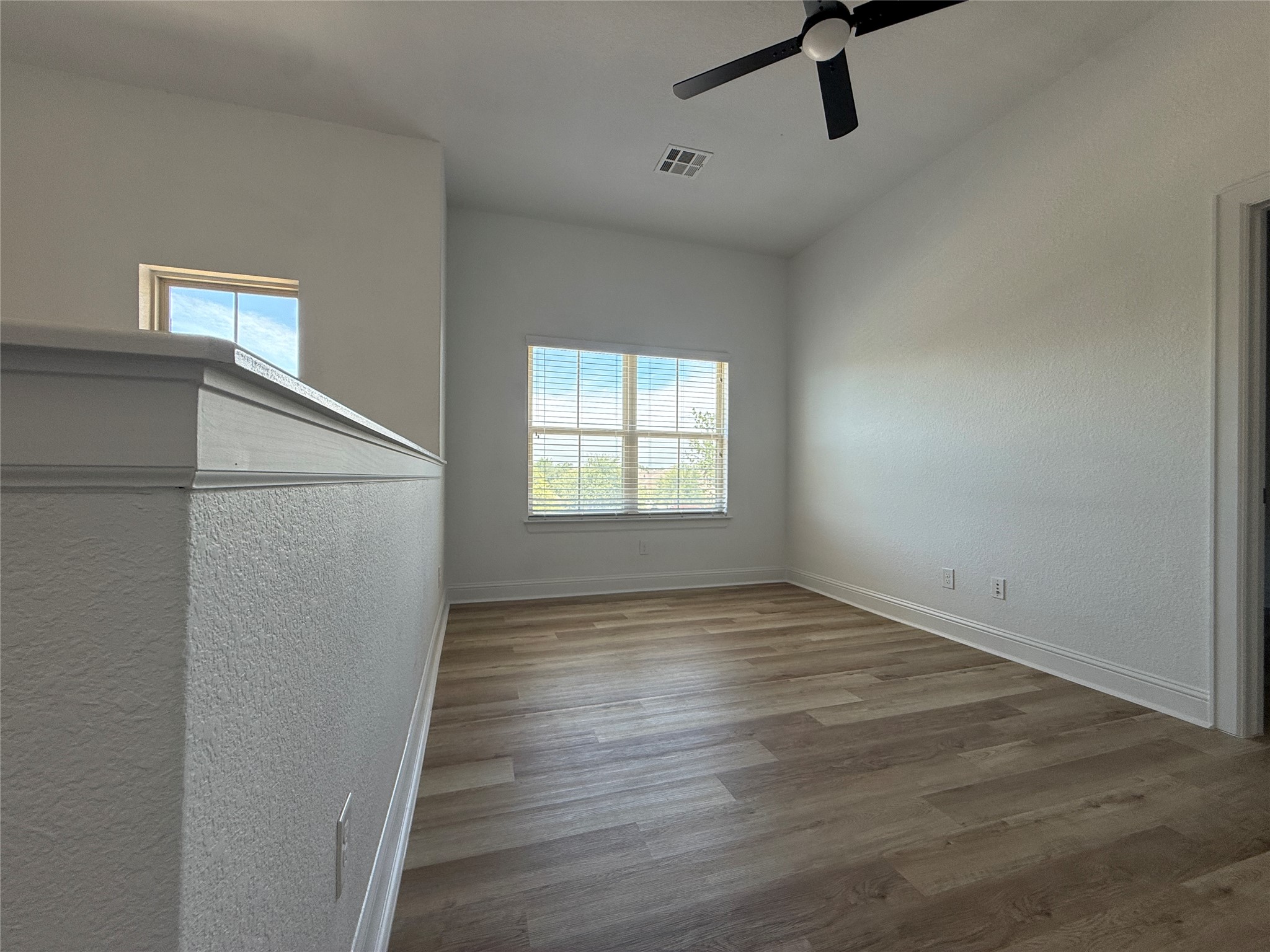 1512 Long Shadow Lane Georgetown, TX 78628 - Photo 14 of 19 a view of empty room with wooden floor and fan