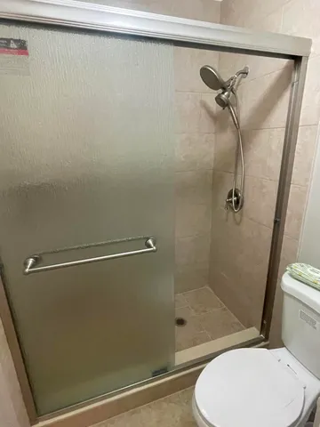 a bathroom with a toilet and a shower