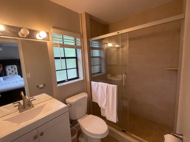 a white toilet sitting next to a bathroom sink
