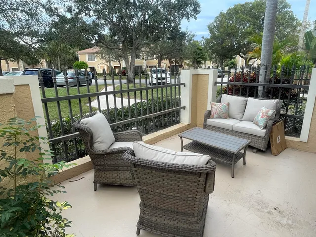 a view of a patio with couches table and chairs