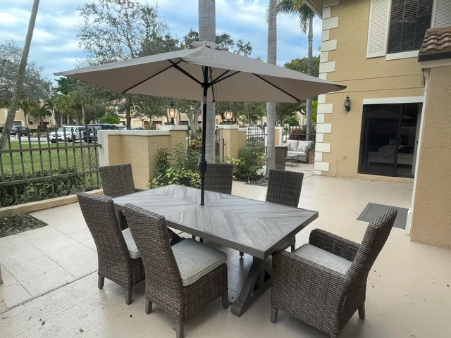 a patio with a patio table and chairs