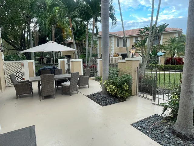 a backyard of a house with yard and outdoor seating