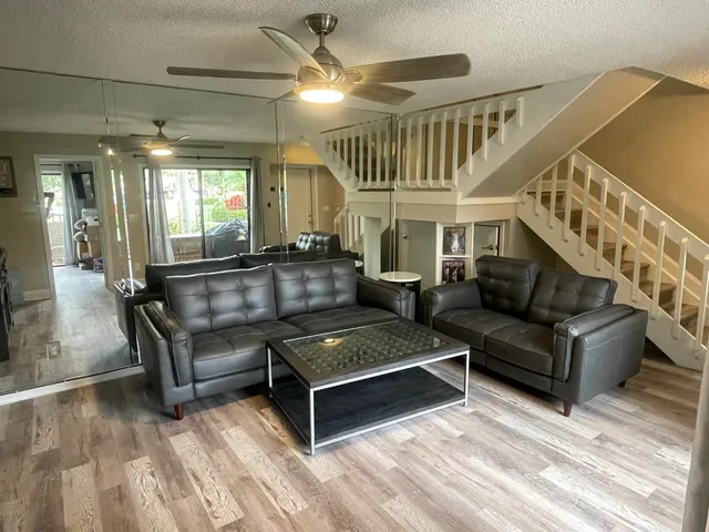 a living room with furniture and a chandelier