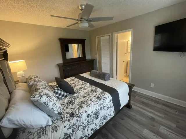 a bedroom with a bed and a flat screen tv