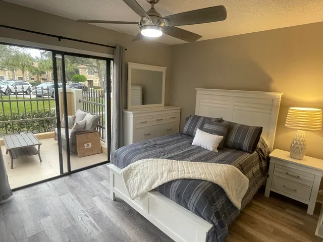 a bedroom with a large bed and a balcony view