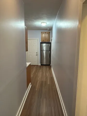 a view of a hallway with wooden floor