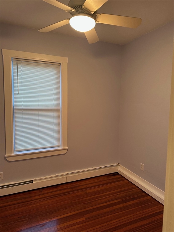 347 Summer Street, Unit 2 Lynn, MA 01905 - Photo 9 of 14 a view of an empty room with wooden floor and a window