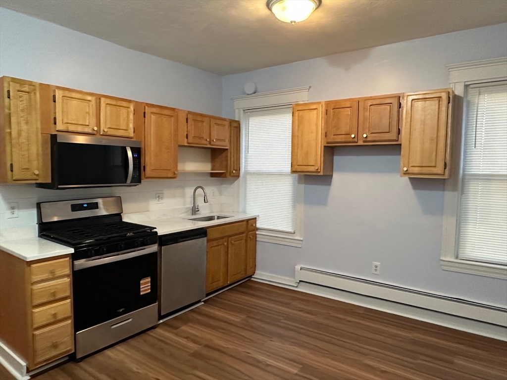 347 Summer Street, Unit 2 Lynn, MA 01905 - Photo 10 of 14 a kitchen with stainless steel appliances a stove a sink and a microwave
