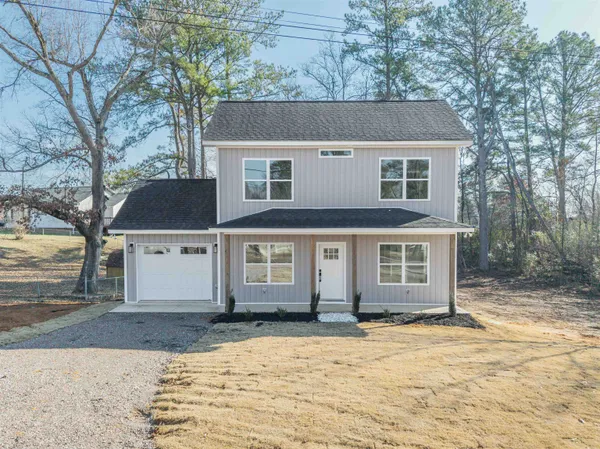 a view of a white house with a yard covered with snow in front of house