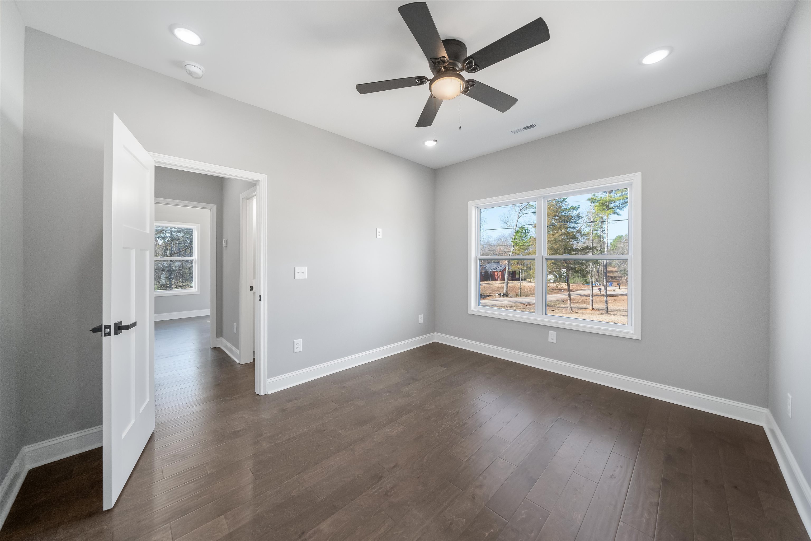 50 Deer Path Road Adamsville, TN 38310 - Photo 15 of 23 an empty room with wooden floor and windows