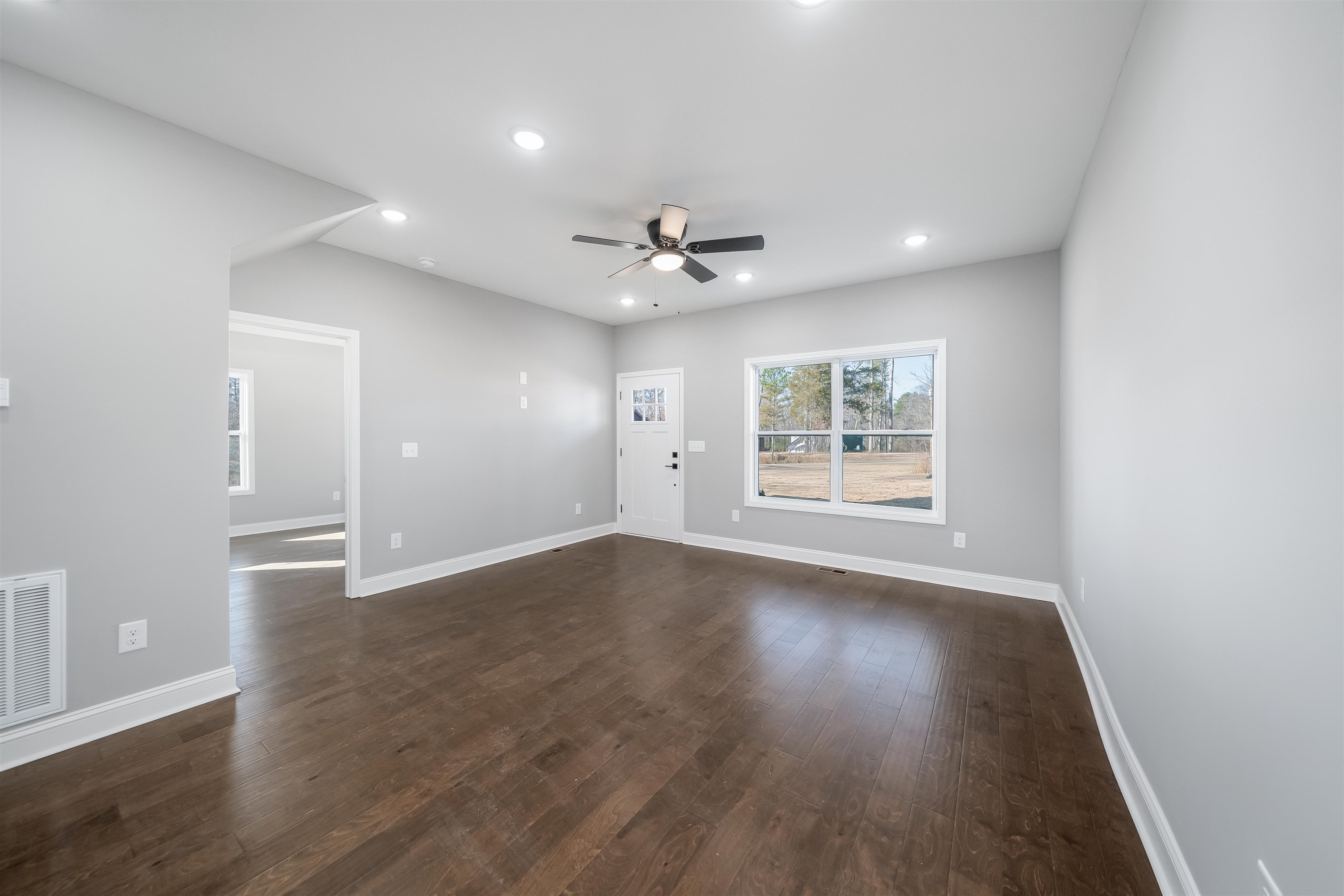 50 Deer Path Road Adamsville, TN 38310 - Photo 5 of 23 a view of an empty room with wooden floor and a window