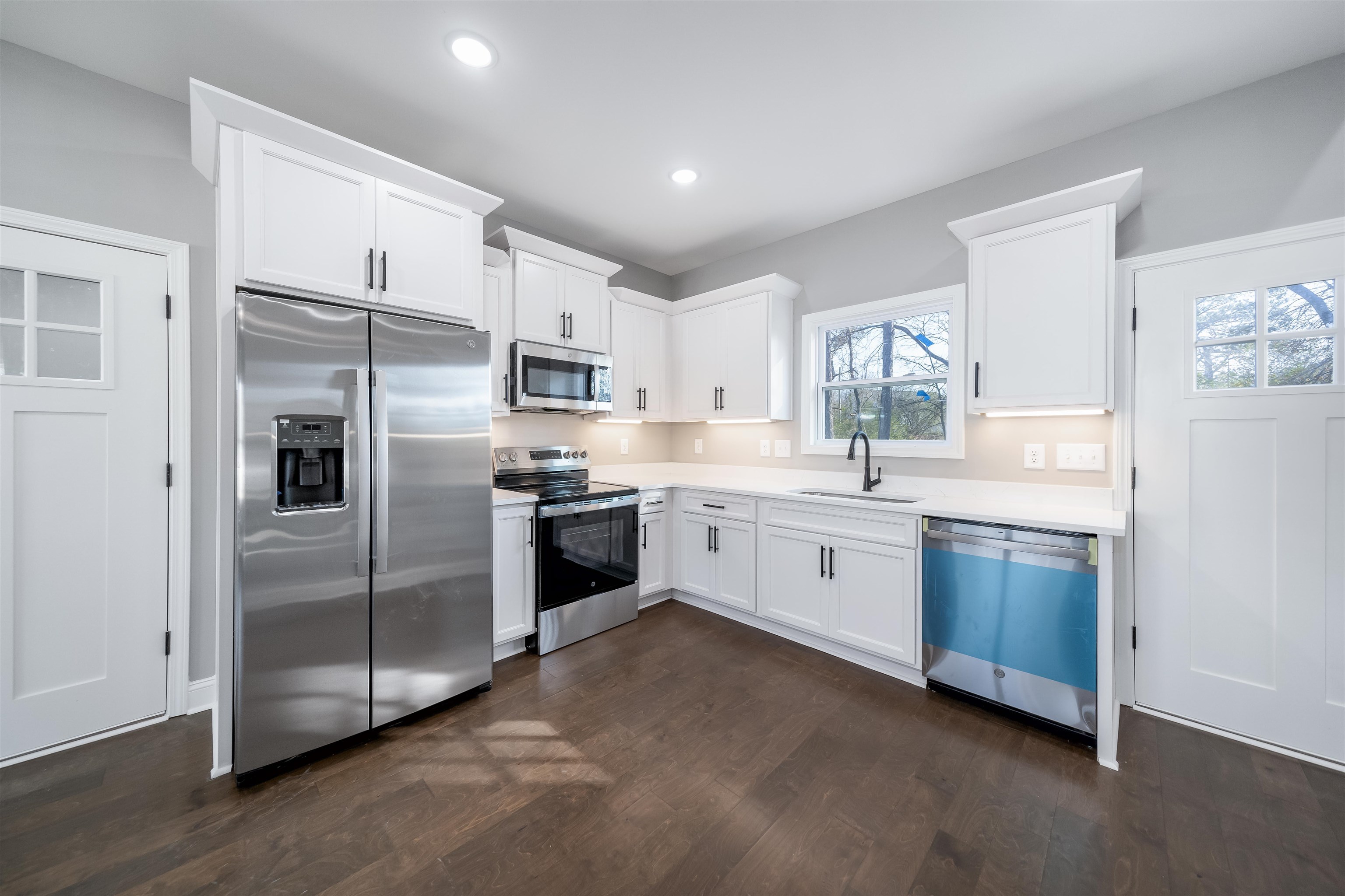 50 Deer Path Road Adamsville, TN 38310 - Photo 7 of 23 a large kitchen with cabinets stainless steel appliances and a window