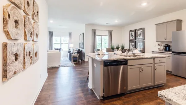 a kitchen with a sink and living room