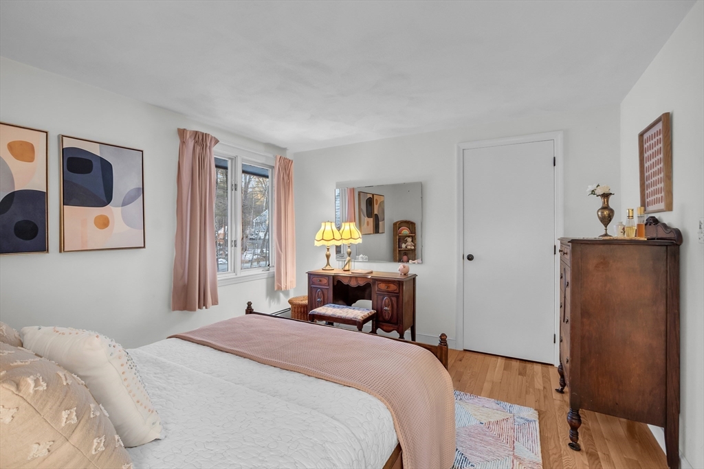 117 Waite Road Boxborough, MA 01719 - Photo 21 of 37 a bedroom with a bed and wooden floor