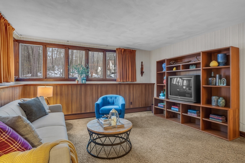 117 Waite Road Boxborough, MA 01719 - Photo 29 of 37 a living room with furniture a window and bookshelf
