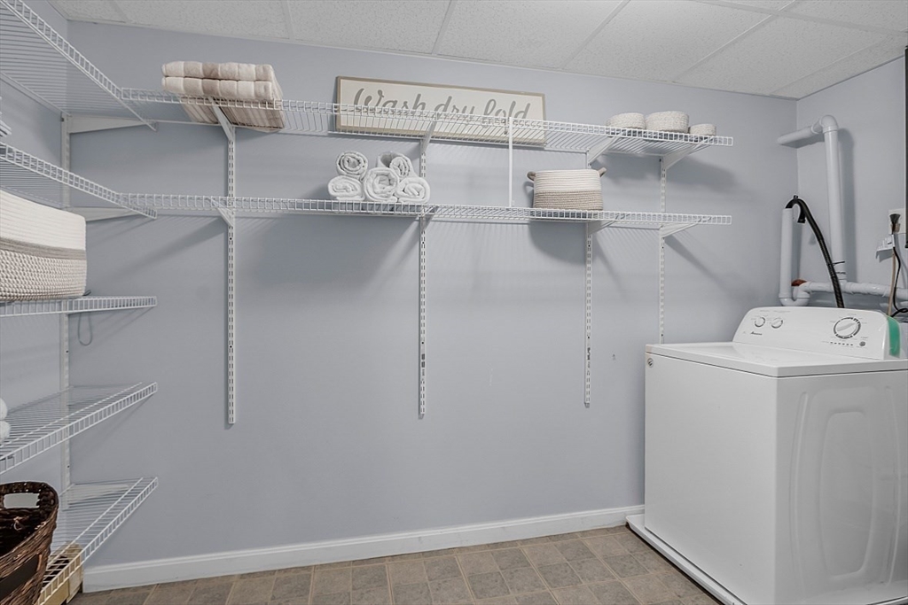 117 Waite Road Boxborough, MA 01719 - Photo 33 of 37 a view of storage and utility room with racks on the wall