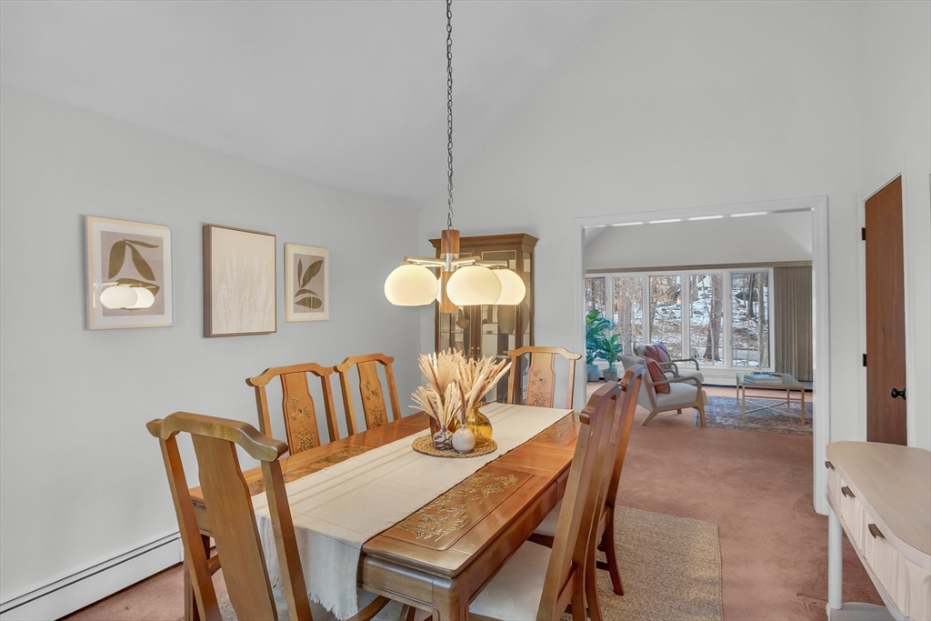 117 Waite Road Boxborough, MA 01719 - Photo 9 of 37 a dining room with furniture a chandelier and wooden floor