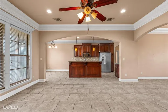 a kitchen with granite countertop a stove a sink and a refrigerator