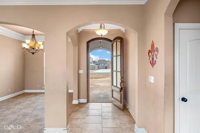 an empty room with windows and fireplace
