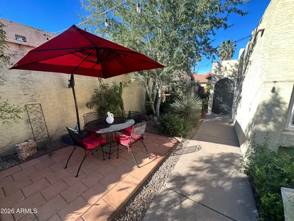 a view of a red chair under an umbrella