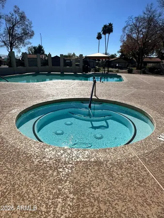 a view of a swimming pool with a yard