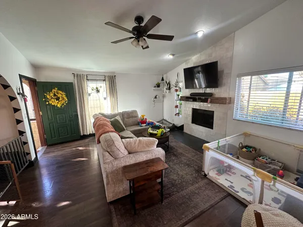 a living room with furniture fireplace and a flat screen tv