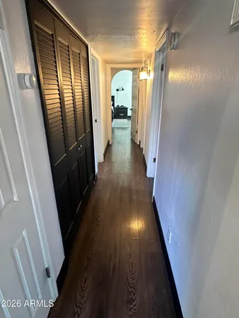 a view of hallway with wooden floor
