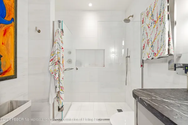 a bathroom with a toilet sink and shower