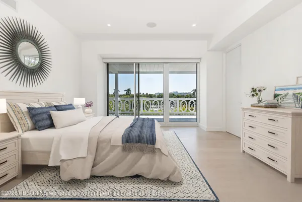 a bedroom with a large bed and a large window