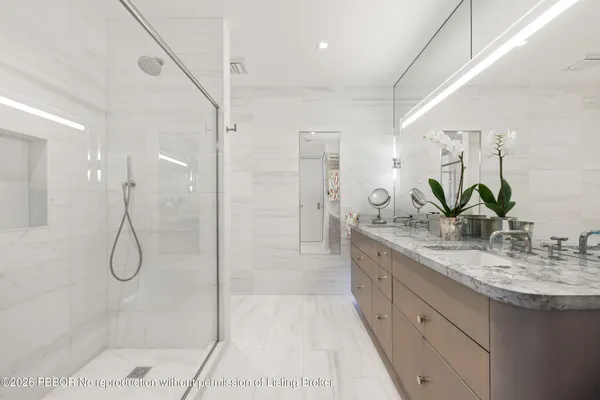 a bathroom with a granite countertop sink a shower and a mirror
