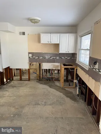 a large kitchen with stainless steel appliances a stove a sink dishwasher and cabinets