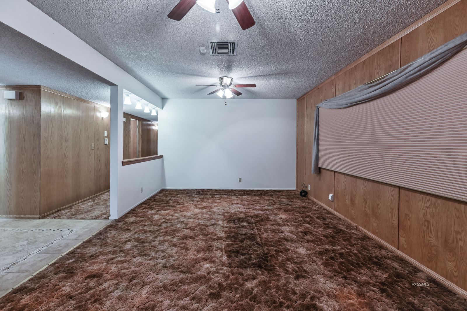 601 South Silver Ridge Street Ridgecrest, CA 93555 - Photo 18 of 34 wooden floor in an empty room with a chandelier fan