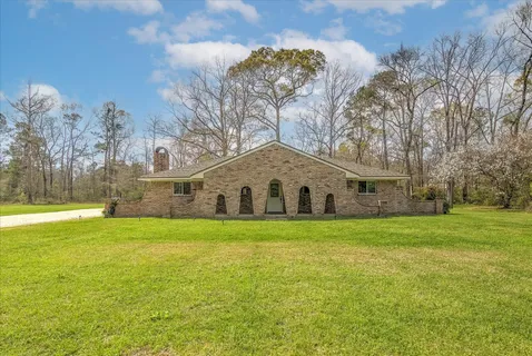 a front view of a house with a big yard