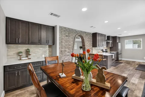 a kitchen with stainless steel appliances granite countertop sink stove top oven and cabinets
