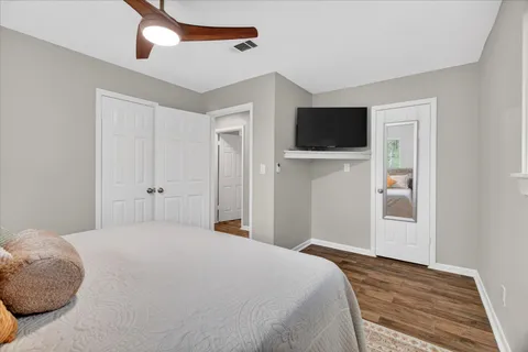 a bedroom with a bed and a flat screen tv
