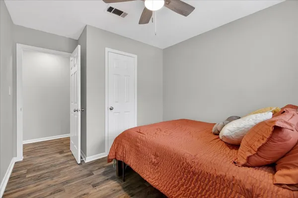 a bedroom with a bed and a ceiling fan
